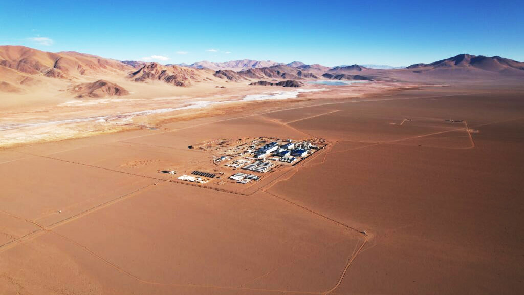 A team of Eramine workers stands in front of the production plant